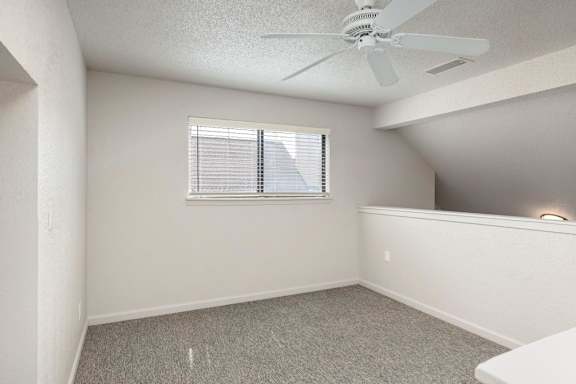 Room with a ceiling fan at AVIA Apartments at 110th Street, Overland Park, 66211