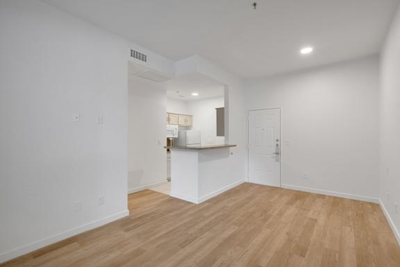 Empty room with kitchen view3 at AVIA Apartments On Alpha, Dallas, TX
