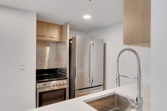 Modern Kitchen with sink and faucet at AVIA Apartments On Alpha, Dallas