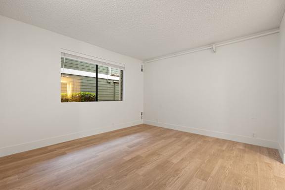 Empty room with window and wooden floor at AVIA Lofts on Parkway, Washington , 98662