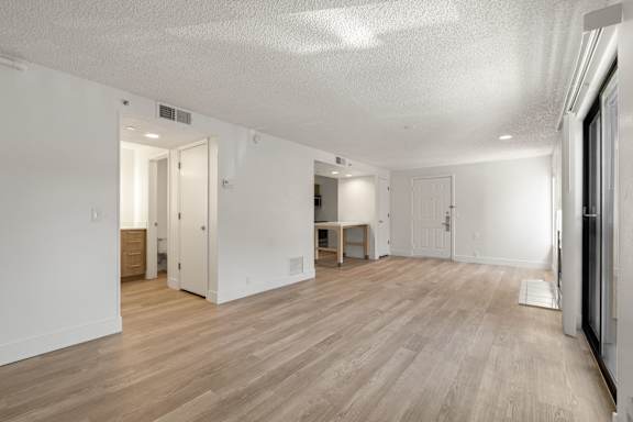 Empty large living room with sliding door at AVIA Lofts on Parkway, Washington