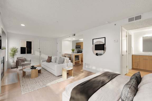Bed with sofa and round table at AVIA Lofts on Parkway, Vancouver Washington