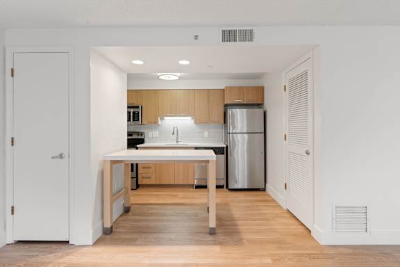 Minimalist Kitchen with Warm Tones at AVIA Lofts on Parkway, Vancouver Washington