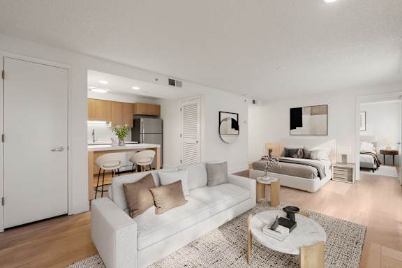 Bright living room with white sofa at AVIA Lofts on Parkway, Vancouver, WA