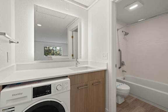 Functional bathroom with brown table unit at AVIA Lofts on Parkway, Washington