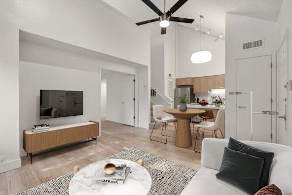 Elegant living room with TV and fan at AVIA Lofts on Parkway, Vancouver