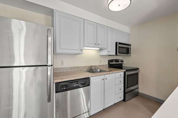 Clean kitchen with appliances setup at AVIA Lofts on Parkway, Vancouver