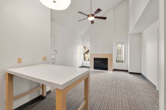 A white table with a fan in a room with a fireplace. at AVIA Lofts on Parkway, Washington