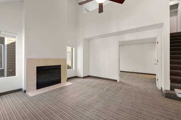 A room with a fireplace and a staircase. at AVIA Lofts on Parkway, Vancouver