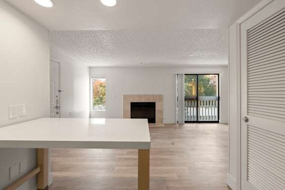 Elegant space with fireplace sliding doors table. at AVIA Lofts on Parkway, Vancouver, 98662