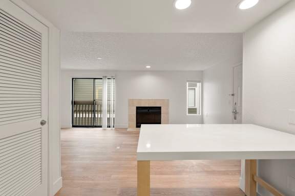 Bright white room with fireplace table. at AVIA Lofts on Parkway, Vancouver