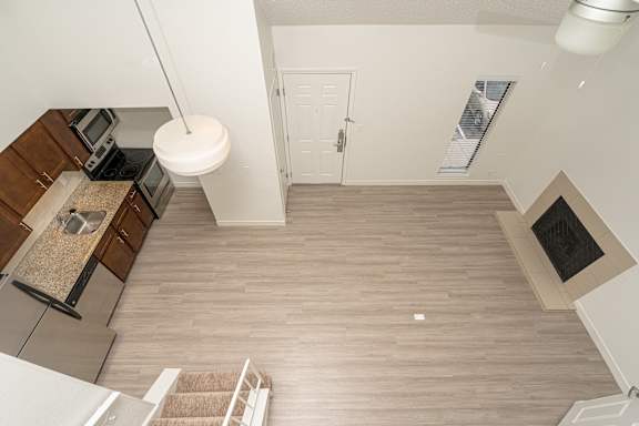 Kitchen with wooden cabinets and stainless steel appliances at AVIA Lofts on Victors Way, Michigan
