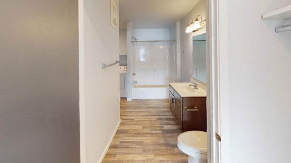 A bathroom with a toilet, sink, and shower. at Red Rock Apartments, Rapid City, South Dakota