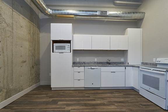 Kitchen with White cabinets and white appliances at Brickside Heights, Utah, 84106