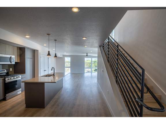 Open concept kitchen with island and dark ceiling at Brickside Heights Apartments, Millcreek