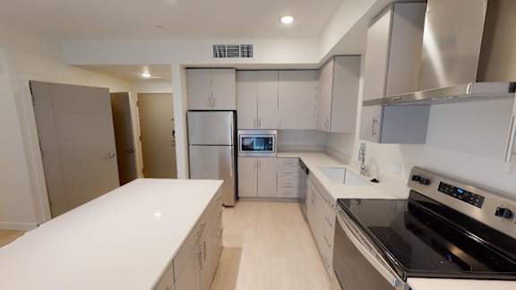 A modern kitchen with a refrigerator, oven, and microwave. at Paperbox Lofts Apartments, Utah