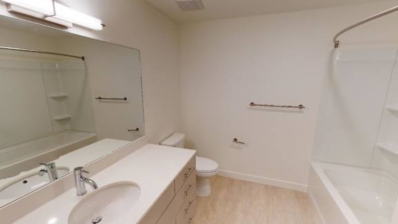 A white bathroom with a sink, toilet, and bathtub. at Paperbox Lofts Apartments, Utah, 84101