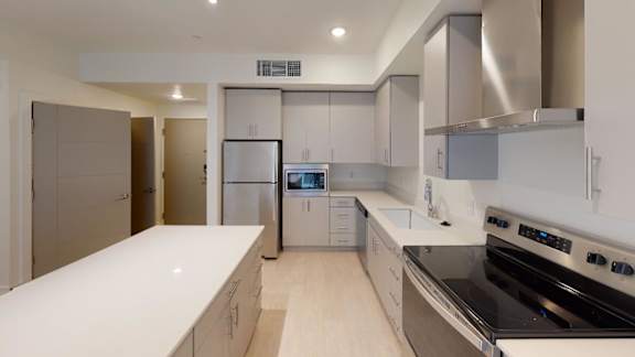 A modern kitchen with stainless steel appliances and white countertops. at Paperbox Lofts Apartments, Salt Lake City  , Utah
