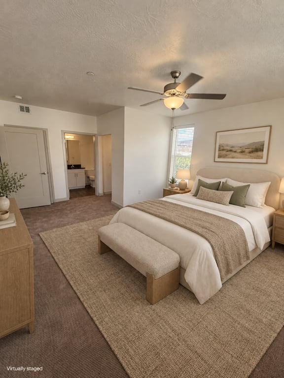 A bedroom with a large bed and a ceiling fan.