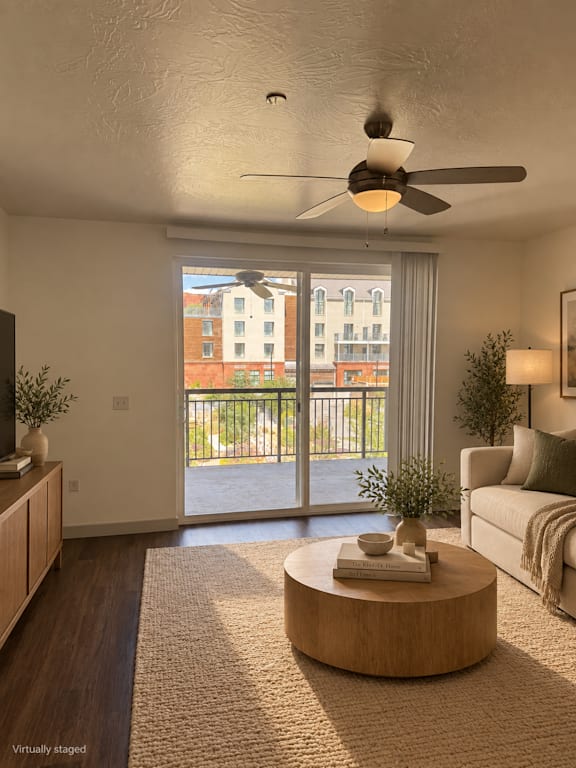 A living room with a ceiling fan and a view of a building outside the window.