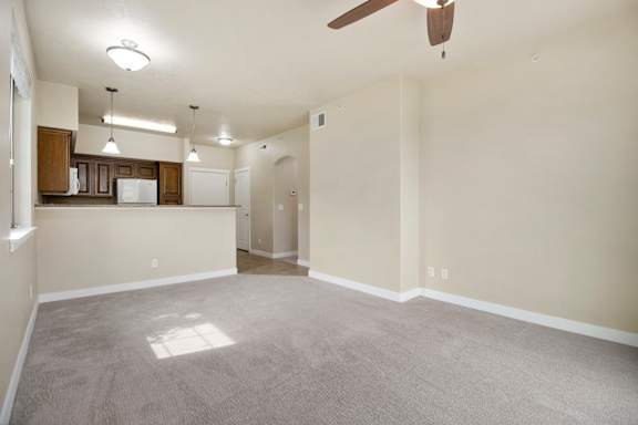 A spacious living room with a ceiling fan and lighting fixtures. at Siena Villas Apartments, Utah