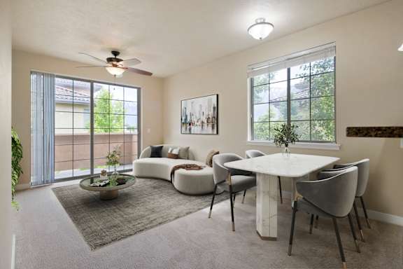 A living room with a white couch, a white coffee table, and a ceiling fan at Siena Villas Apartments, Orem