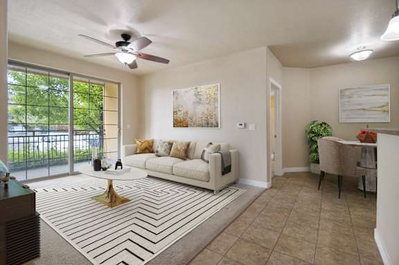 A living room with a white couch and a rug with a black and white pattern at Siena Villas Apartments, Utah, 84097