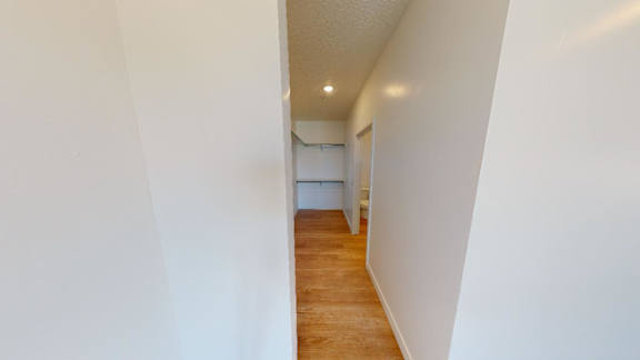 A long hallway with a door at the end.
