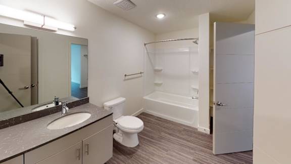 A bathroom with a toilet, sink, and bathtub. at Paperbox Lofts Apartments, Salt Lake City  , 84101