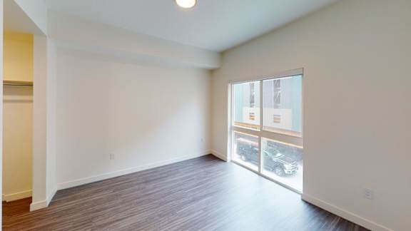 A room with a window overlooking a parking lot. at Paperbox Lofts Apartments, Salt Lake City  , UT, 84101