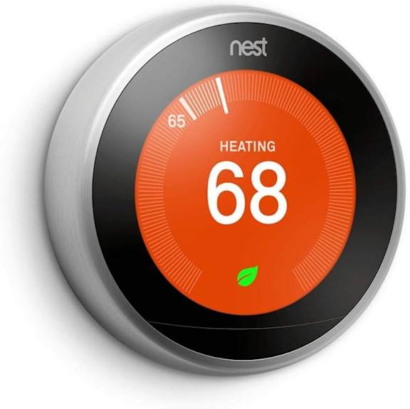 A Nest thermostat displays a heating temperature of 68 degrees.