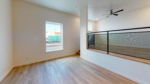 A room with a window and a fan.