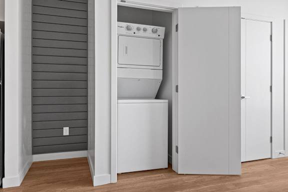 A white dishwasher is open in a kitchen.