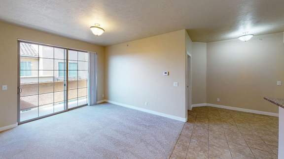 A room with a sliding glass door leading to a balcony. at Siena Villas Apartments, Orem