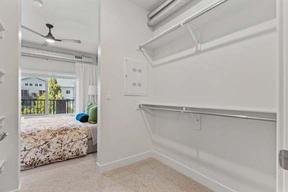 A bedroom with a bed, a window, and a fan. at The Revival, Salt Lake City
