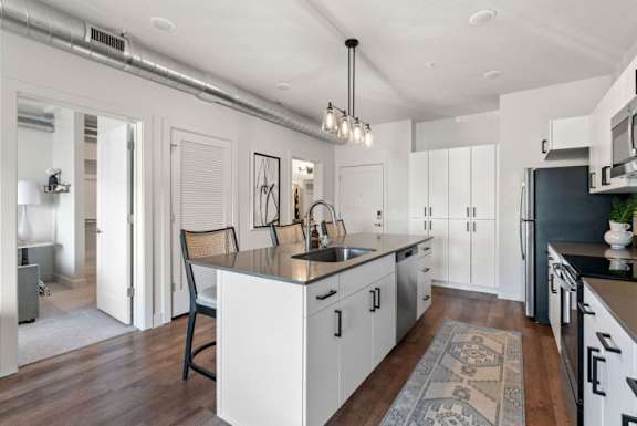 A modern kitchen with white cabinets and a center island.