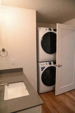 Bathroom with stacked washer dryer and undermount sink at The Revival Apartments, Salt Lake City, 84101