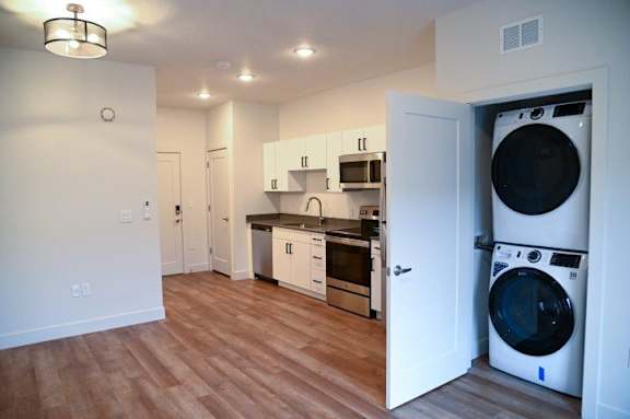 Studio apartment with kitchen and stacked washer dryer at The Revival Apartments, Salt Lake City, Utah