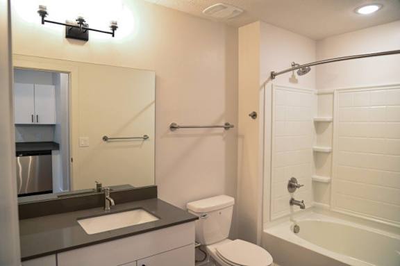 Modern bathroom with tub shower combo at The Revival Apartments, Salt Lake City, UT 84101
