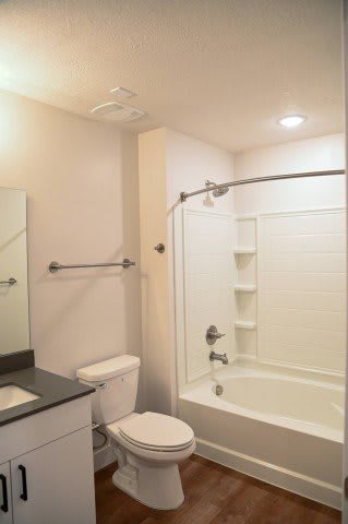 Bathroom with tub shower combo and modern fixtures at The Revival Apartments, Salt Lake City, UT