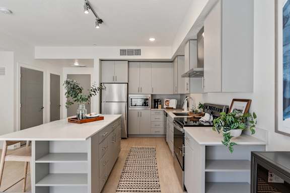 A modern kitchen with a white countertop and stainless steel appliances. at Paperbox Lofts Apartments, Salt Lake City