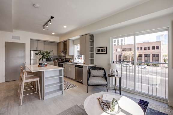 A modern kitchen with a dining table and chairs. at Paperbox Lofts Apartments, Apartments, Salt Lake City  , UT