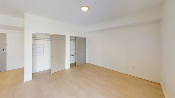 A large empty room with wooden floors and white walls. at Paperbox Lofts Apartments, Apartments, Salt Lake City  , UT