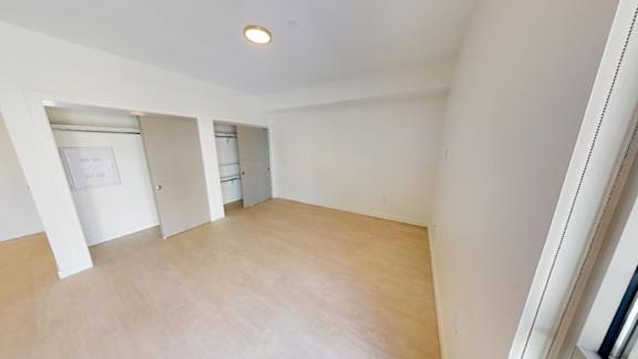 A room with a white ceiling and wooden floor. at Paperbox Lofts Apartments, Utah, 84101