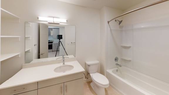 A white bathroom with a sink, toilet, and bathtub. at Paperbox Lofts Apartments, Salt Lake City  , 84101