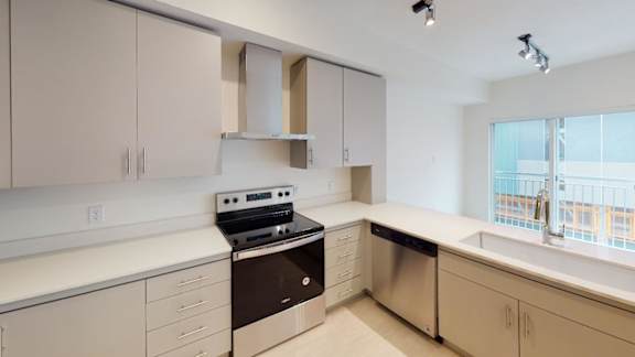 A kitchen with a stove, sink, and cabinets. at Paperbox Lofts Apartments, Salt Lake City