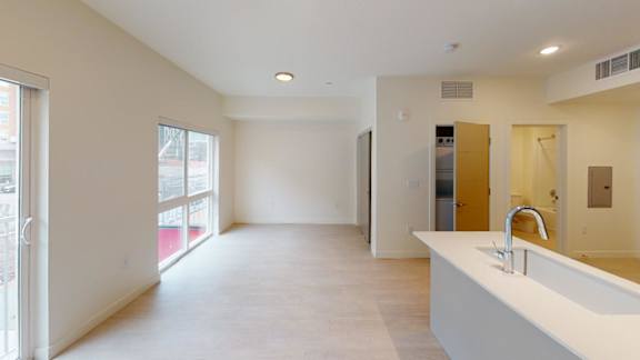A large, empty room with a sink and a window. at Paperbox Lofts Apartments, Salt Lake City  , UT, 84101