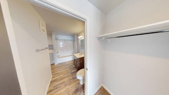 A white bathroom with a toilet and sink at Red Rock Apartments, South Dakota