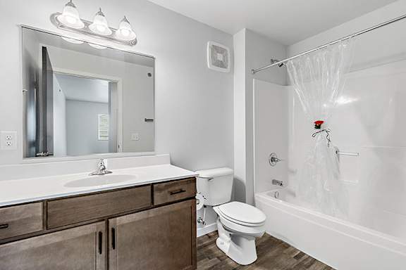 a bathroom with a toilet sink and bathtub at Red Rock Apartments, Rapid City, SD