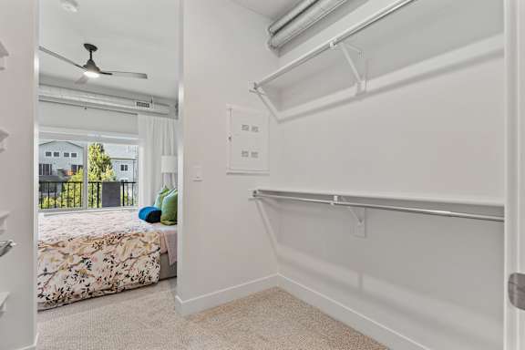 A bedroom with a bed, a window, and a fan. at The Revival, Salt Lake City